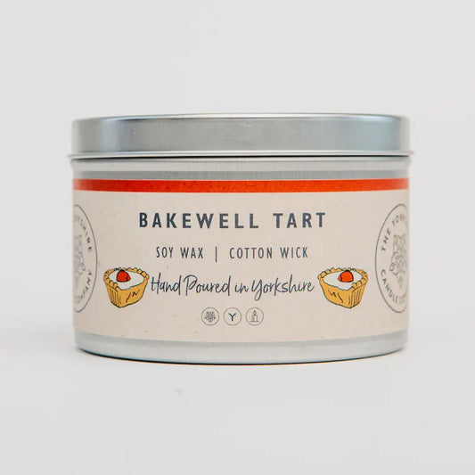 Candle tin labeled 'Bakewell Tart' with a white background
