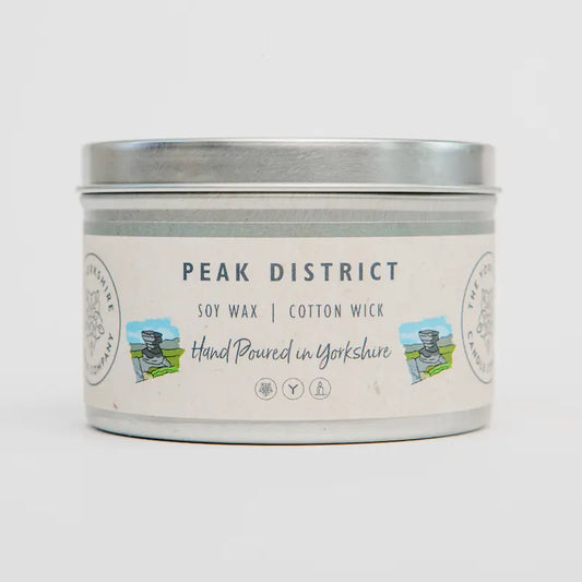 Candle tin labeled 'Peak District' with soy wax and cotton wick on a white background