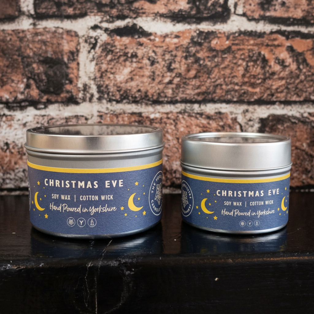 Christmas Eve candles by The Yorkshire Candle Company, showing the large tin on the left and small tin on the right.