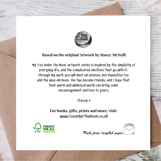 Card with text and branding on a wooden surface