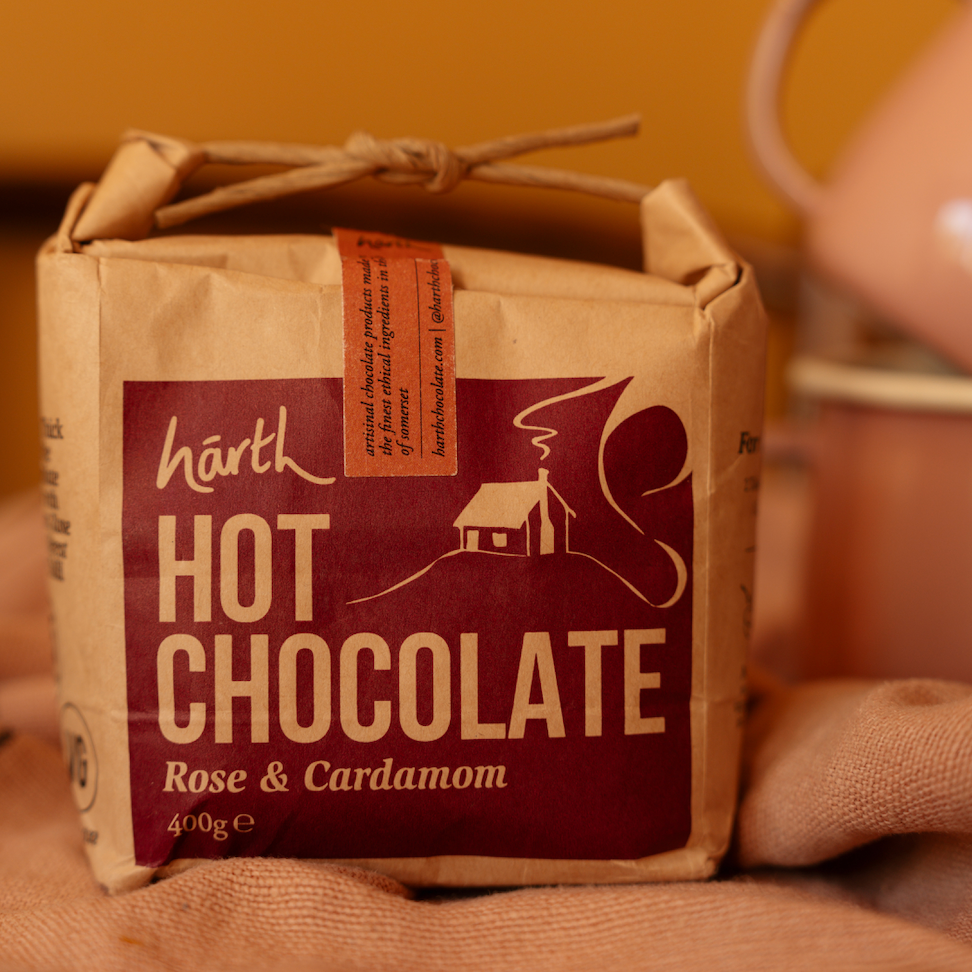 Box of Harth Hot Chocolate with Rose & Cardamom flavor on a wooden surface.