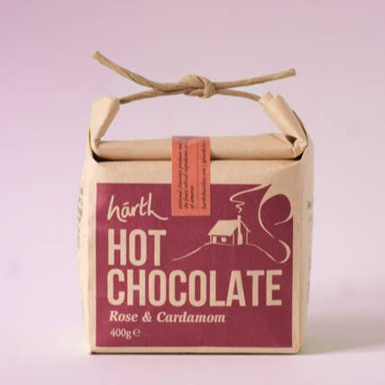 Box of Harth Hot Chocolate with rose and cardamom flavor on a light purple background