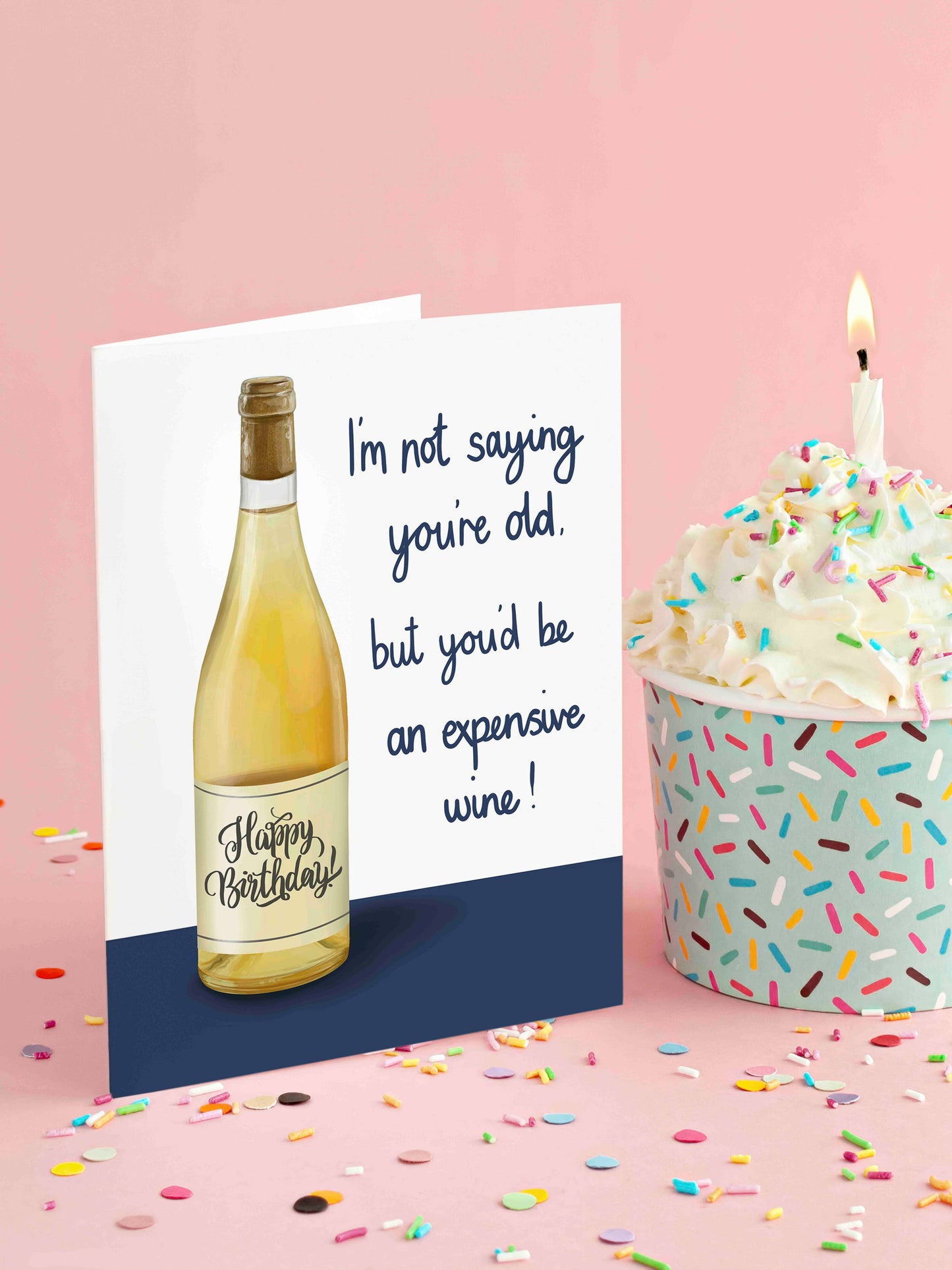 Birthday card with wine bottle design and birthday cake on a pink background