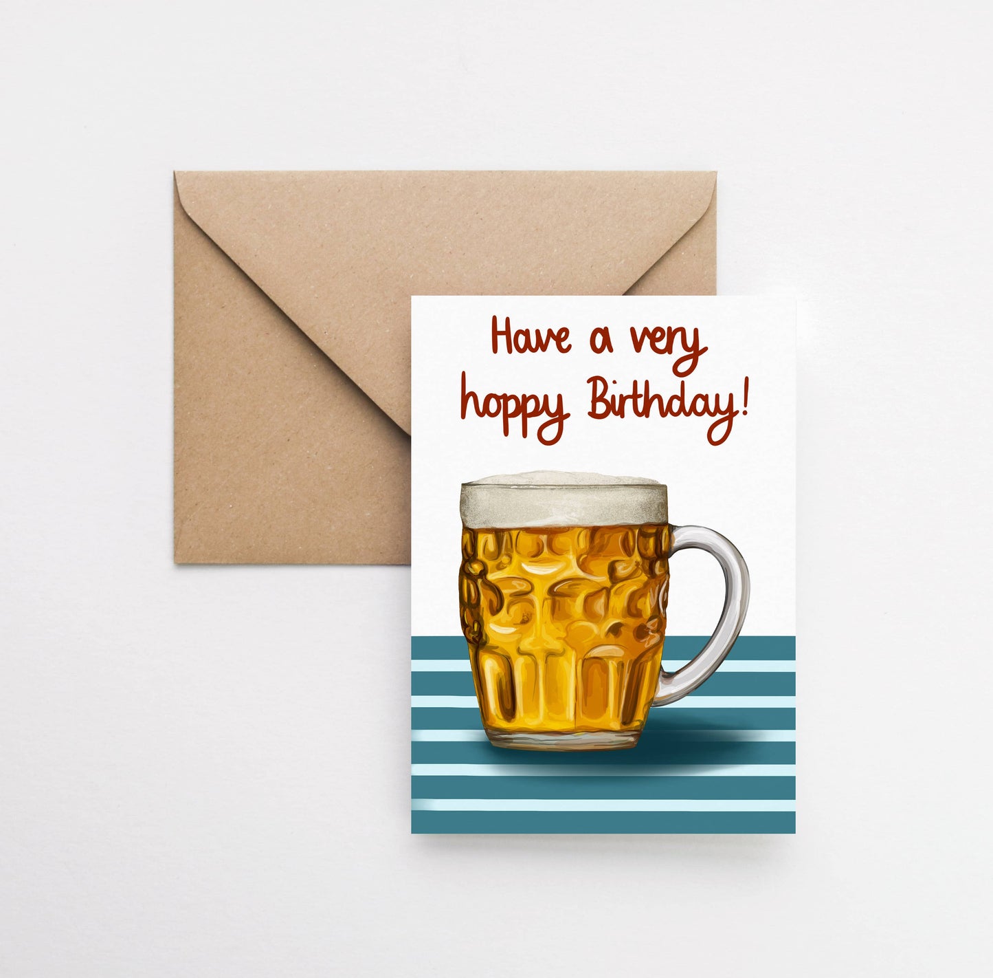 Birthday card with a mug of beer and 'Have a very happy Birthday!' text, accompanied by a brown envelope on a white background.