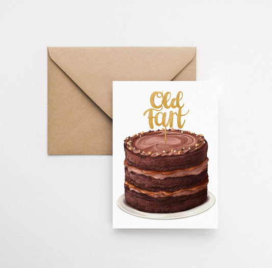 Greeting card with a chocolate cake illustration and 'Old Fan' text, accompanied by a brown envelope on a white background.