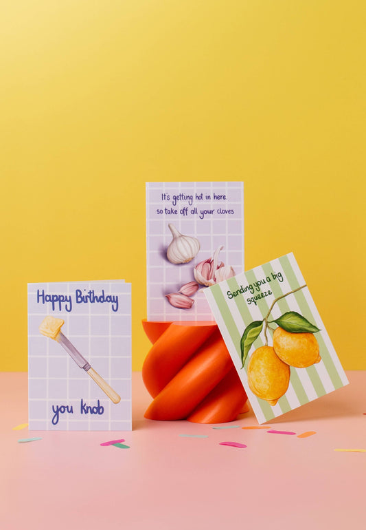 Three greeting cards with different designs on a yellow background