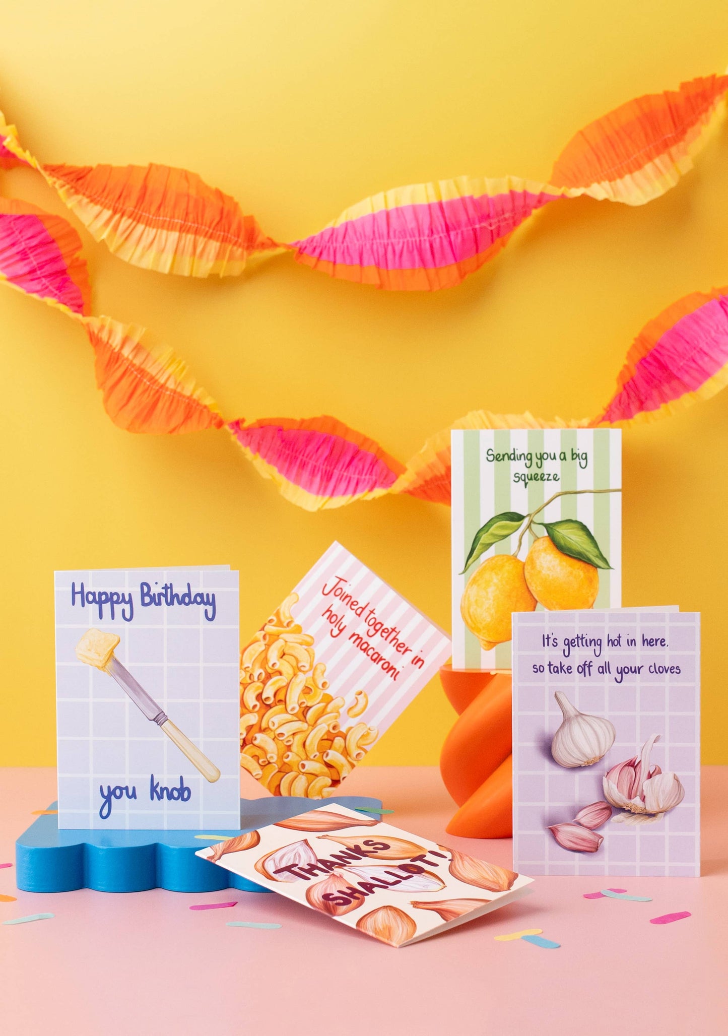 Colorful greeting cards and decorative items on a yellow background