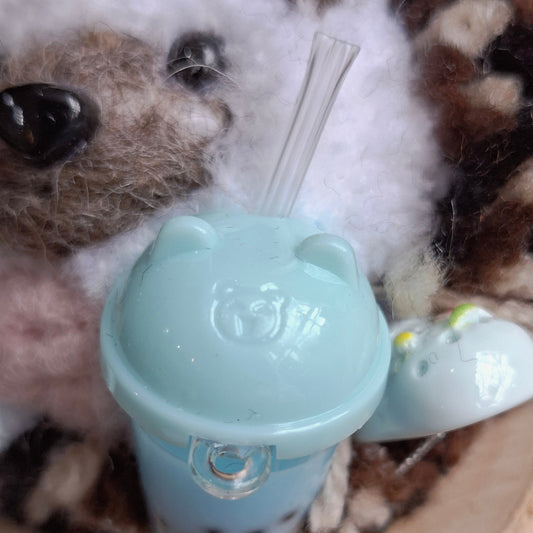 Small hedgehog ornament with a blue bobo tea bottle and straw i