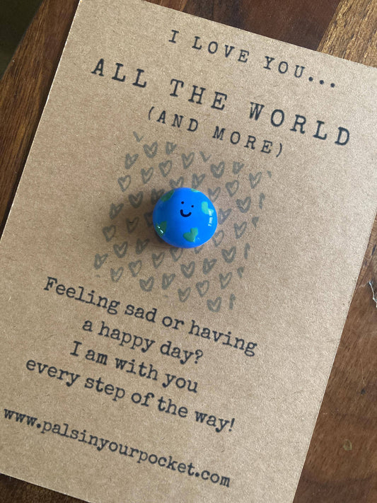 Card with a blue smiley face token and text on a wooden surface