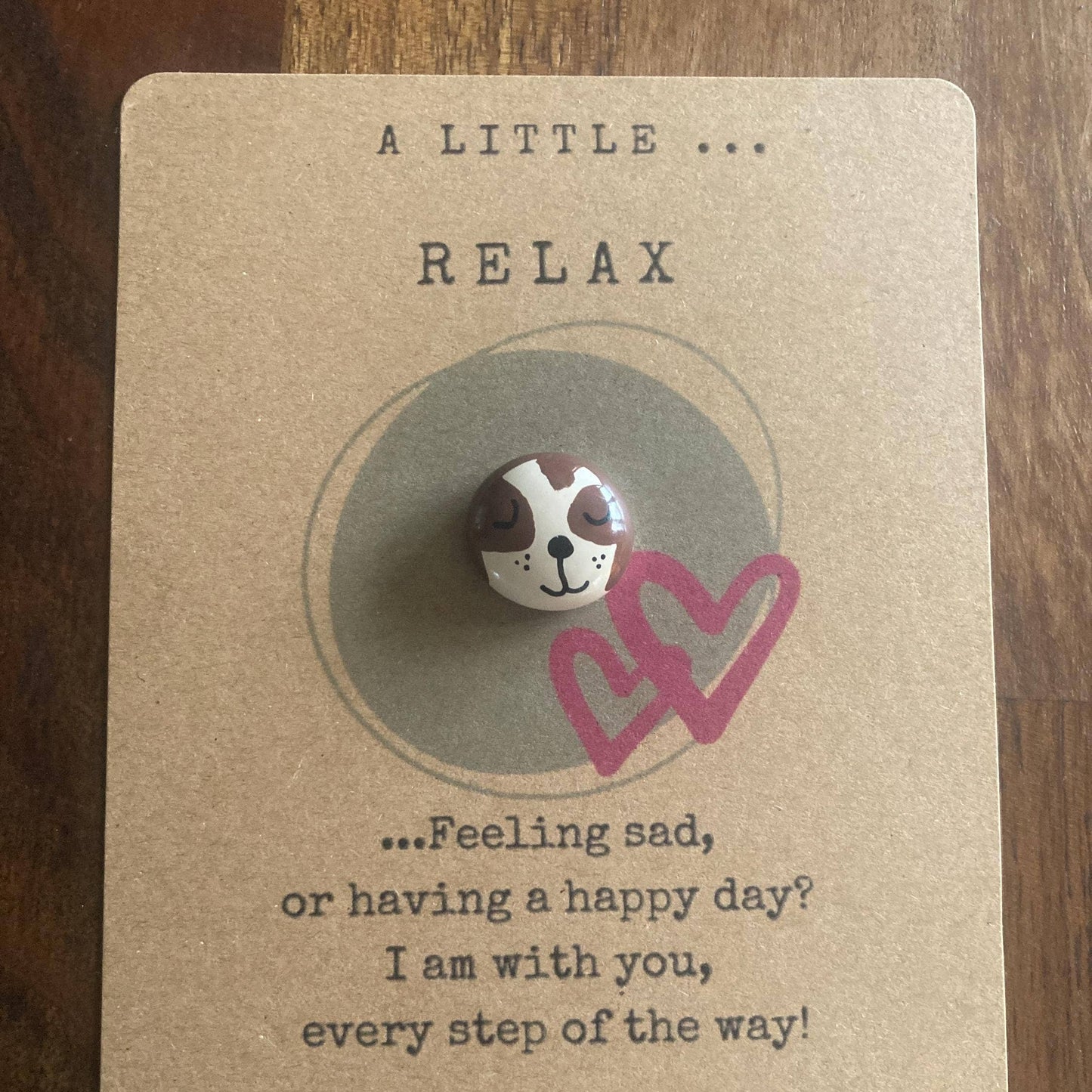 Pin with a sloth design on a card with text L