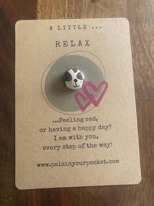 Pebble with a sloth design on a card with text