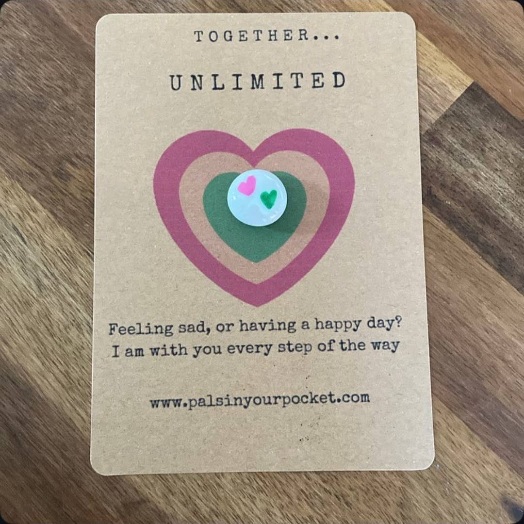Card with a heart design and text on a wooden surface