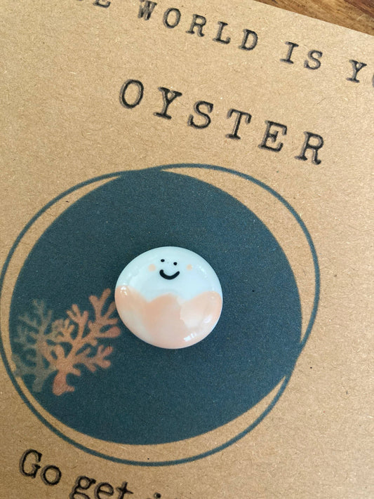 Token with a smiley face design on a card with text and a circular design.