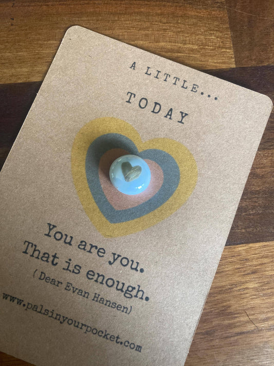 card with heart design and text on a wooden surface
