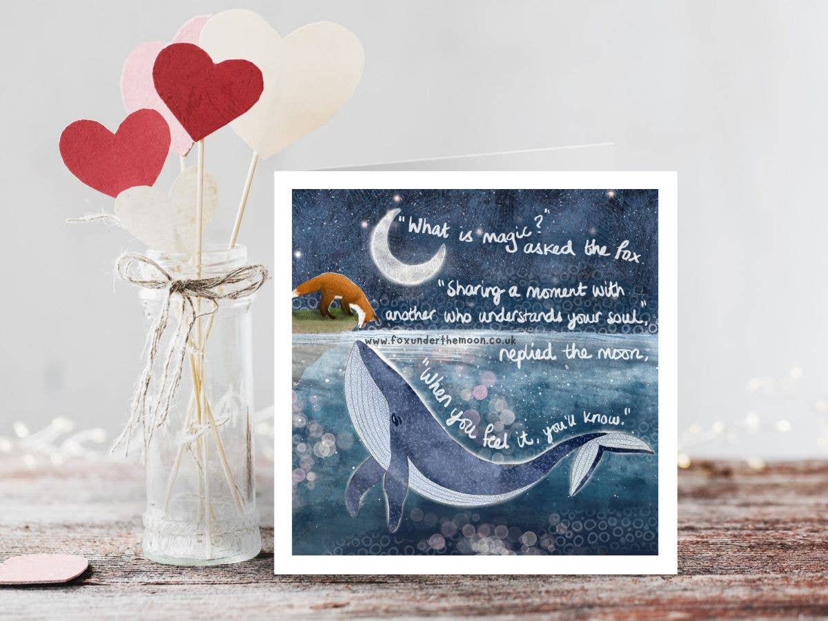 Card with whale illustration and inspirational quote next to heart-shaped objects in a jar.