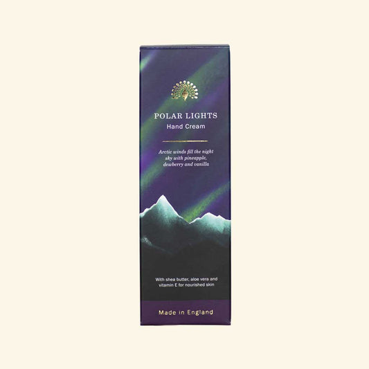 Polar Lights hand cream packaging with mountain and aurora design on a beige background