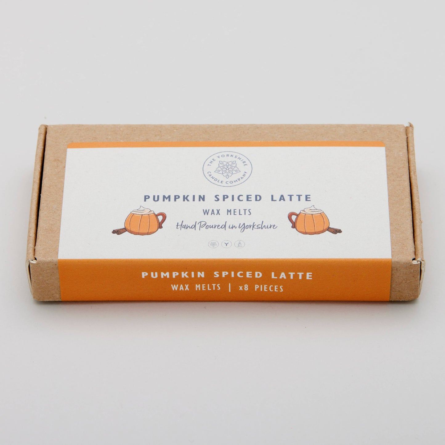 Box of pumpkin spiced latte wax melts on a light gray background