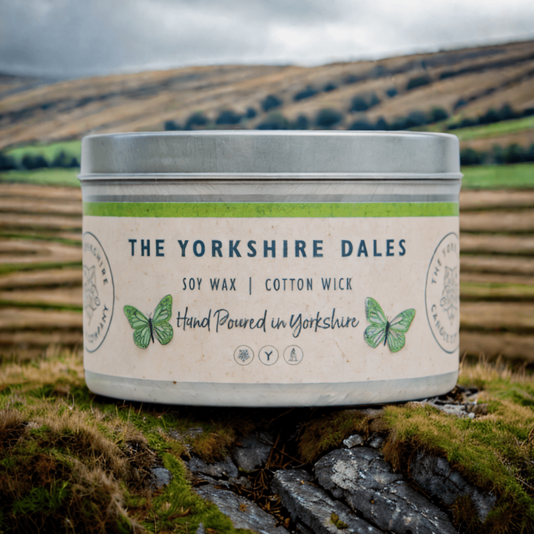 Candle container with 'The Yorkshire Dales' branding against a natural landscape.