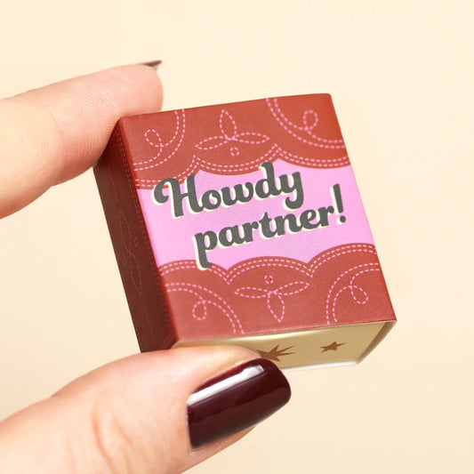 Tiny matchbox gift featuring a ceramic cowboy boot, perfect western-themed encouragement token