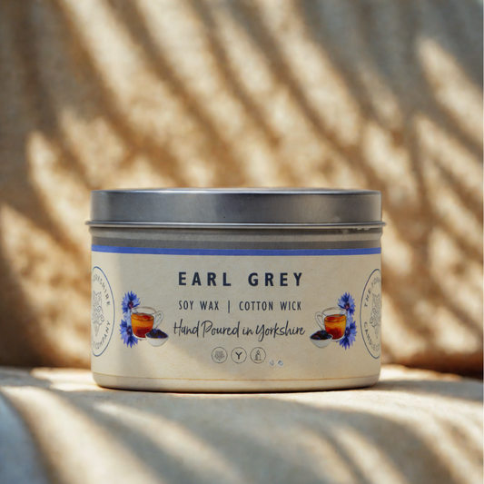Candle jar labeled 'Earl Grey' with a decorative label on a neutral background