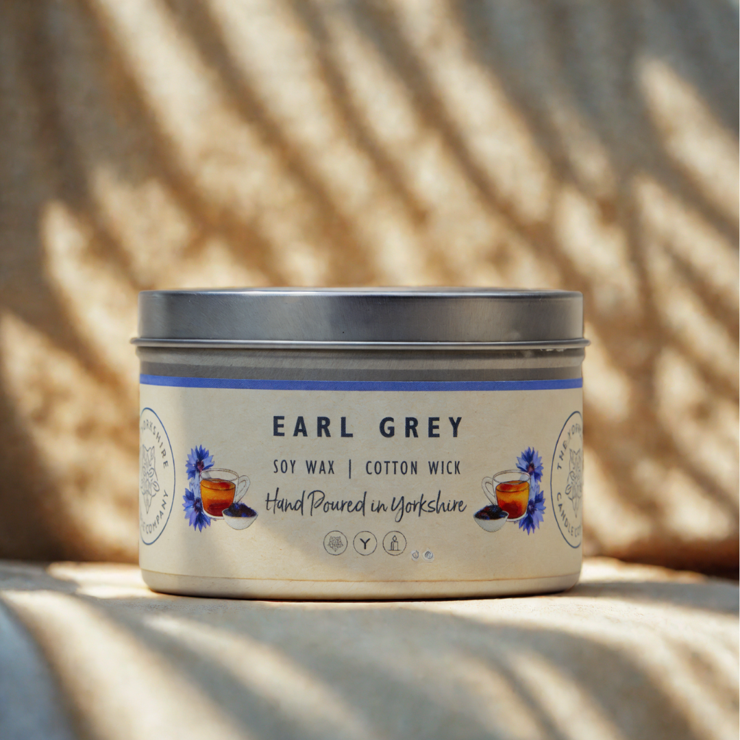Candle jar labeled 'Earl Grey' with a decorative label on a neutral background