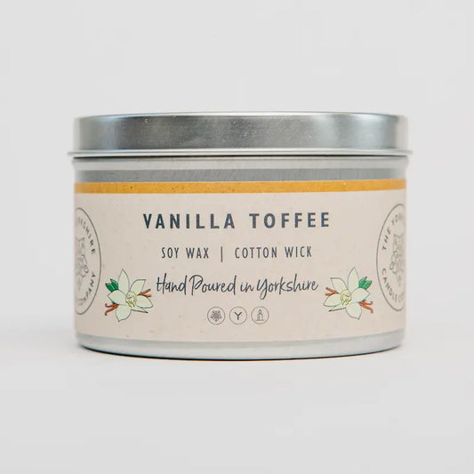 Vanilla toffee candle in a tin with a label on a white background