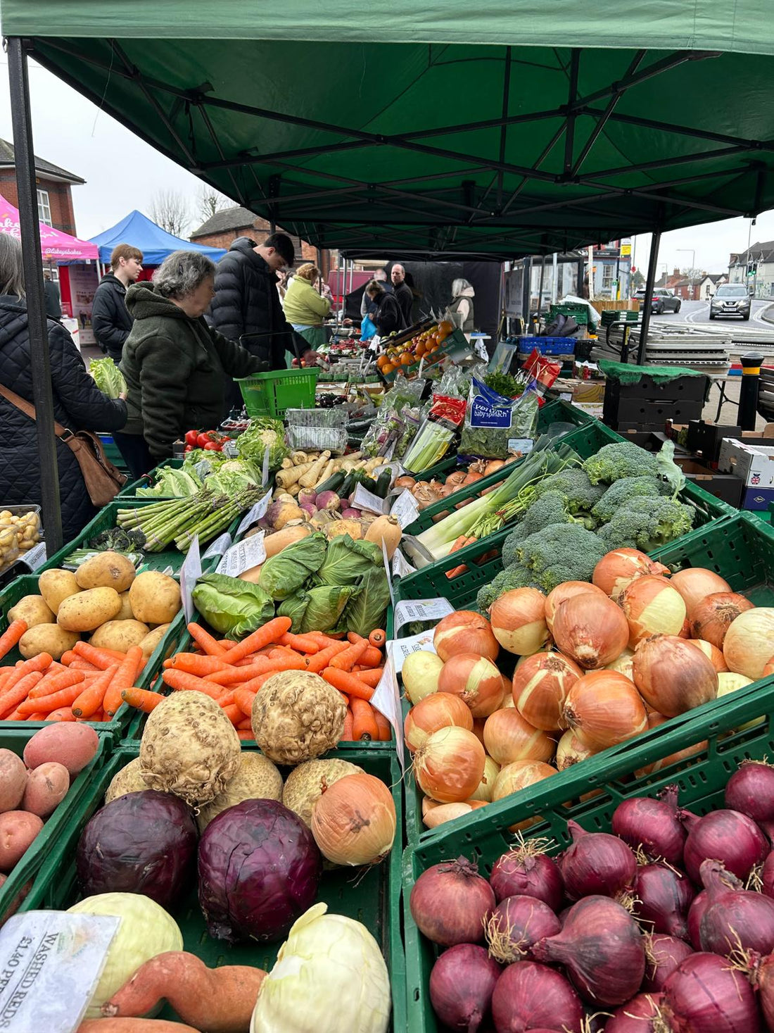 Kegworth Market Place bustling with visitors and stalls on a sunny market day