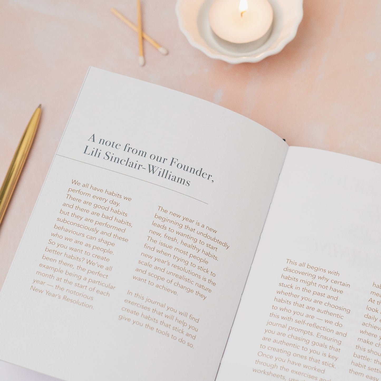 Open book with text on a soft pink background with candles and matches.