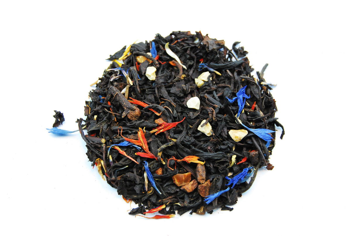 Christmas / Winter black loose leaf tea with almond pieces, cinnamon and colourful flower petals on white