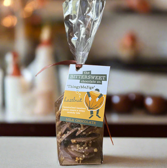 Packaged chocolate treat with a label on a wooden surface