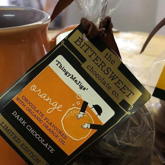 Dark chocolate buttons with packaging labeled 'Orange' from the Bittersweet Chocolate Co. brand.