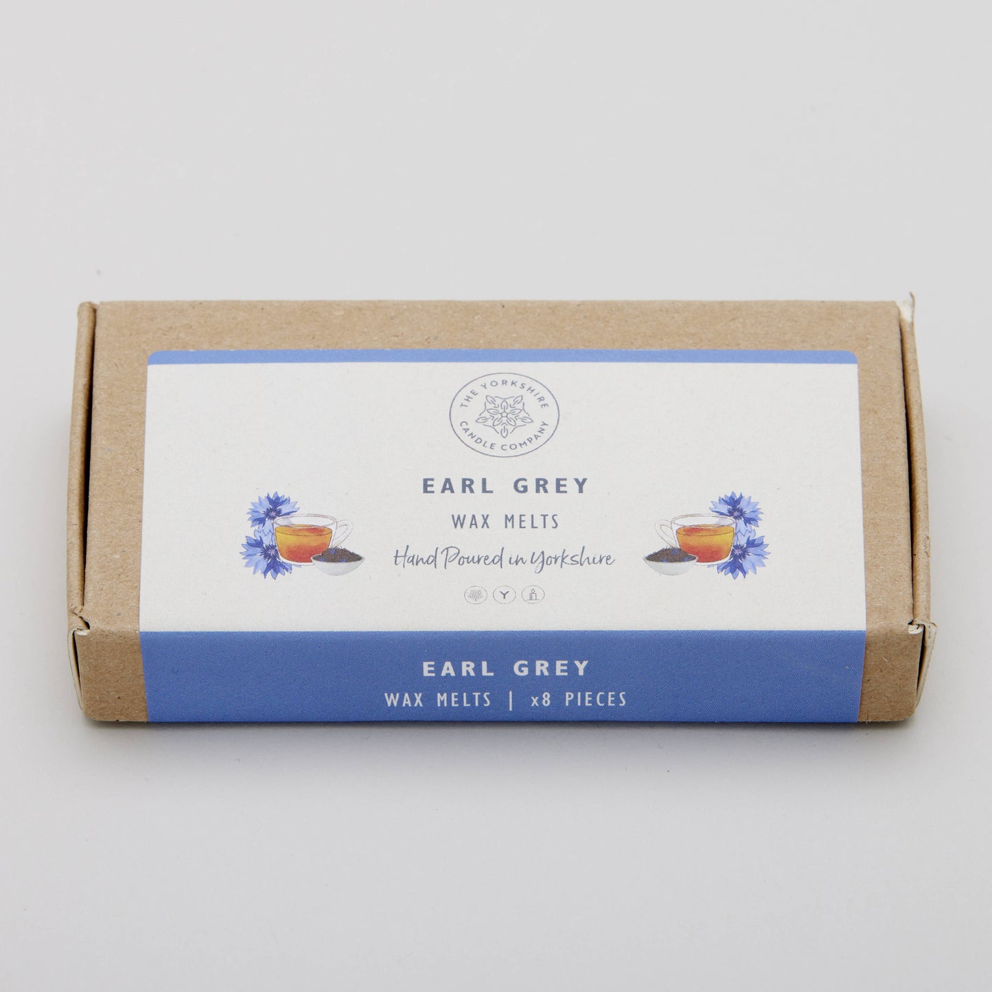Box of Earl Grey wax melts with a white label on a light gray background