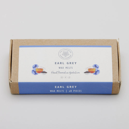 Box of Earl Grey wax melts with a white label on a light gray background