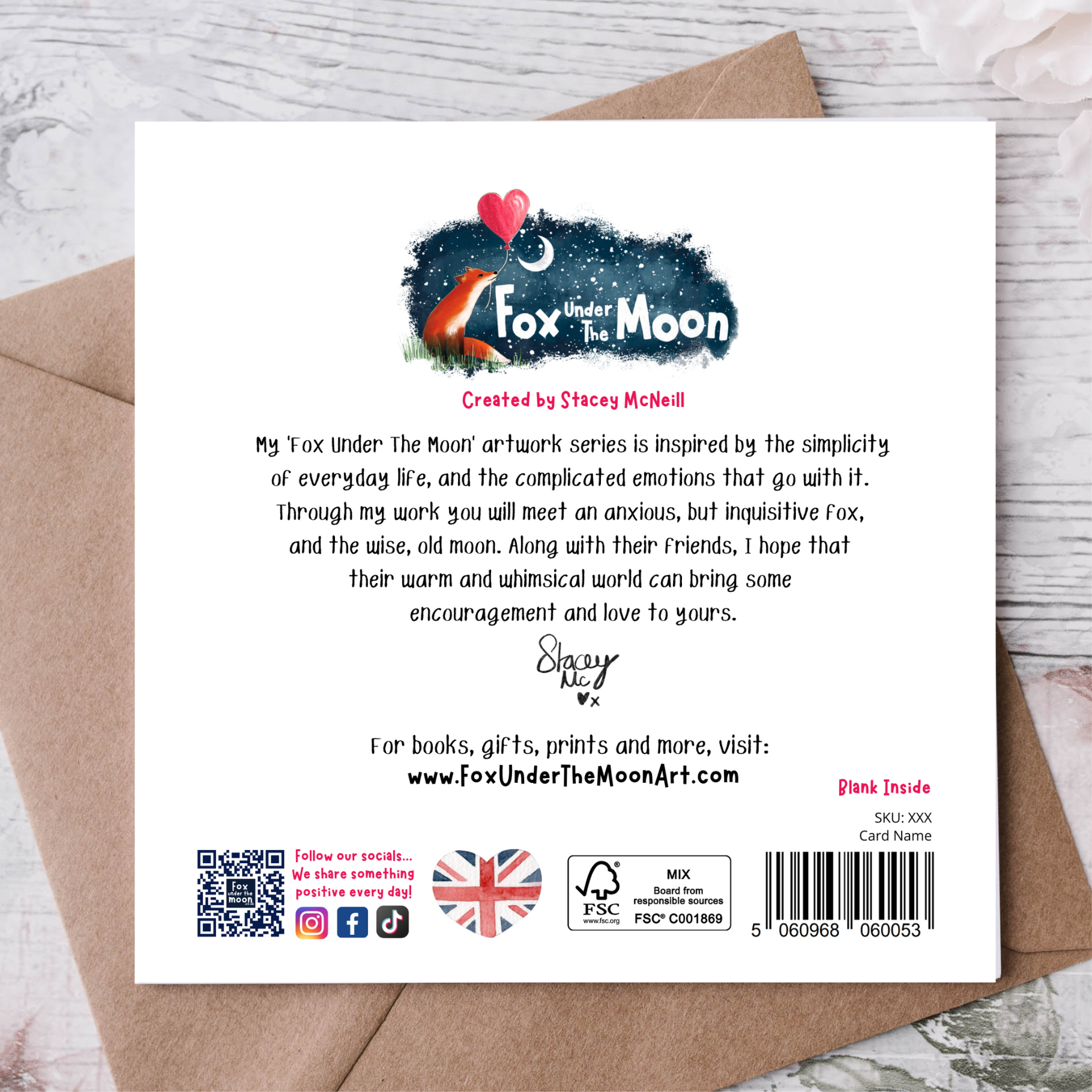 Back of a card with 'Fox Under The Moon' branding and text on a wooden surface