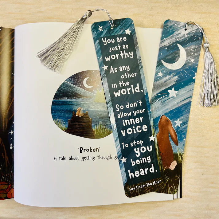 Bookmarks with motivational quote and illustrations on a book page