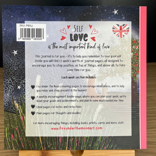 Back cover of a journal with text and design elements on a wooden surface