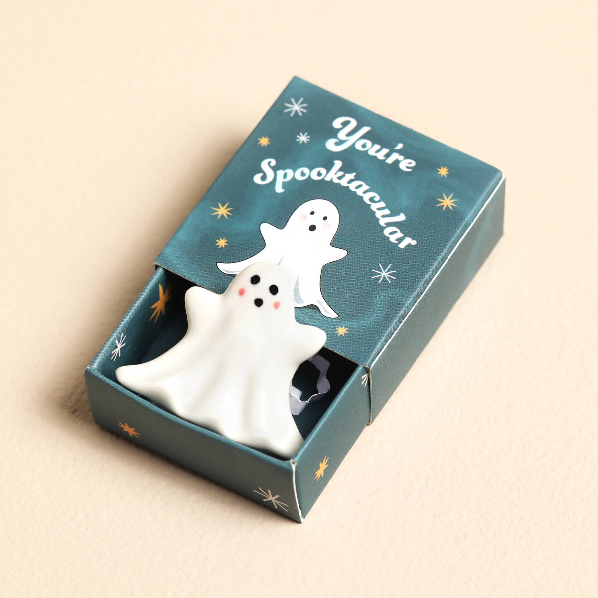 Ghost figurine in a decorative box with 'You're Spooktacular' text on a beige background