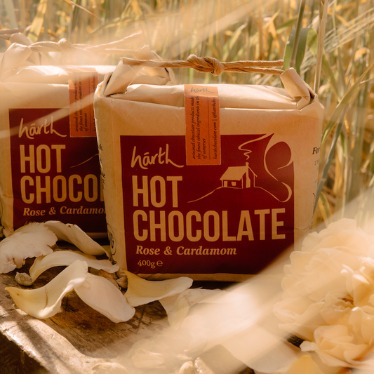 Two packages of Hark Hot Chocolate with a rustic background