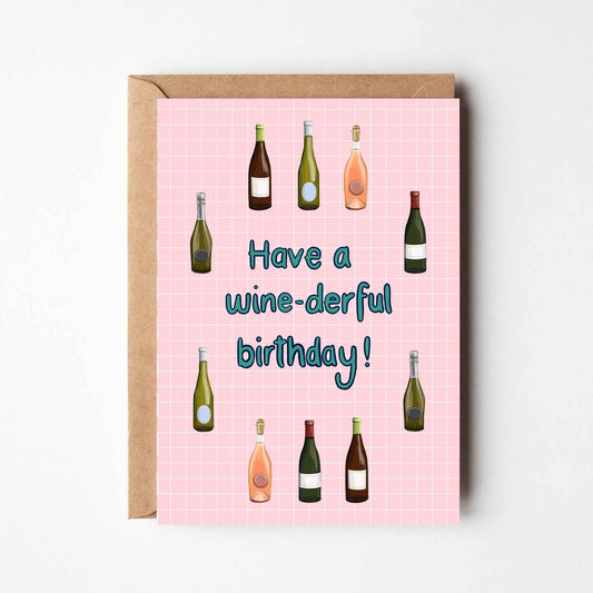 Greeting card with wine bottle illustrations and 'Have a wine-derful birthday!' text on a pink background.