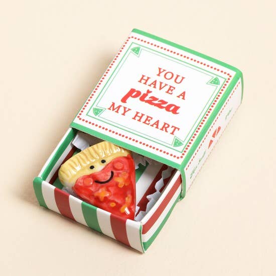 Matchbox with pizza-themed novelty item and 'You have a pizza my heart' text on a beige background
