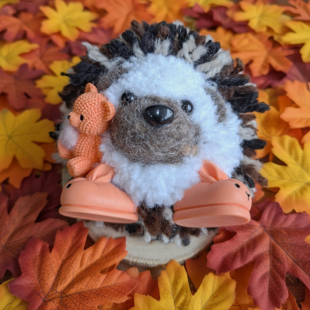 Plush  hedgehog with a teddybear and slippers