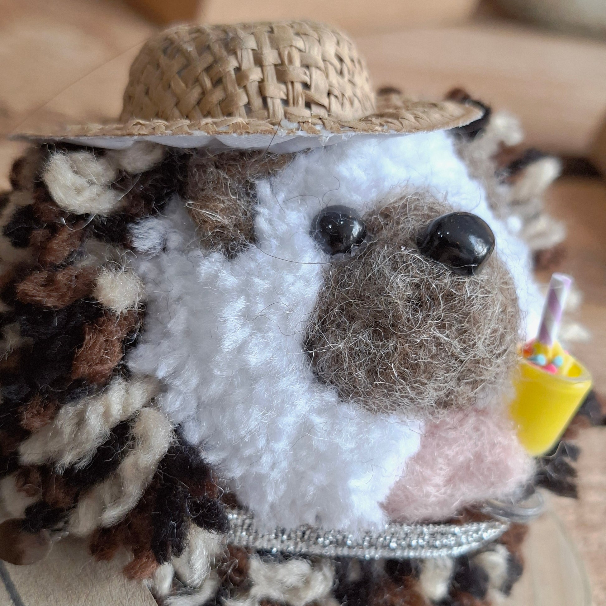 Small plush toy with a textured surface on a wooden background