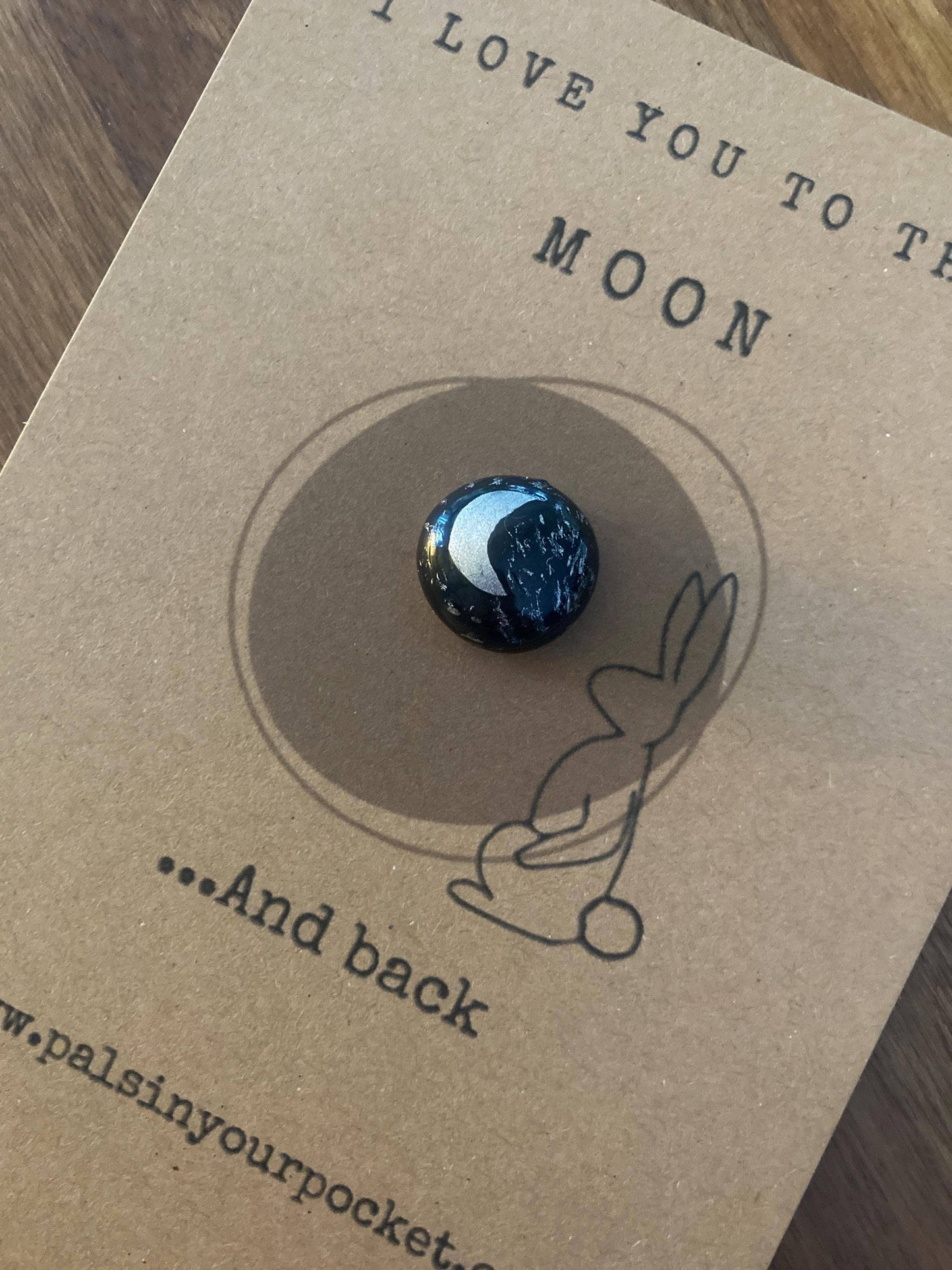 Pebble with moon design on a 'I love you to the moon and back' card