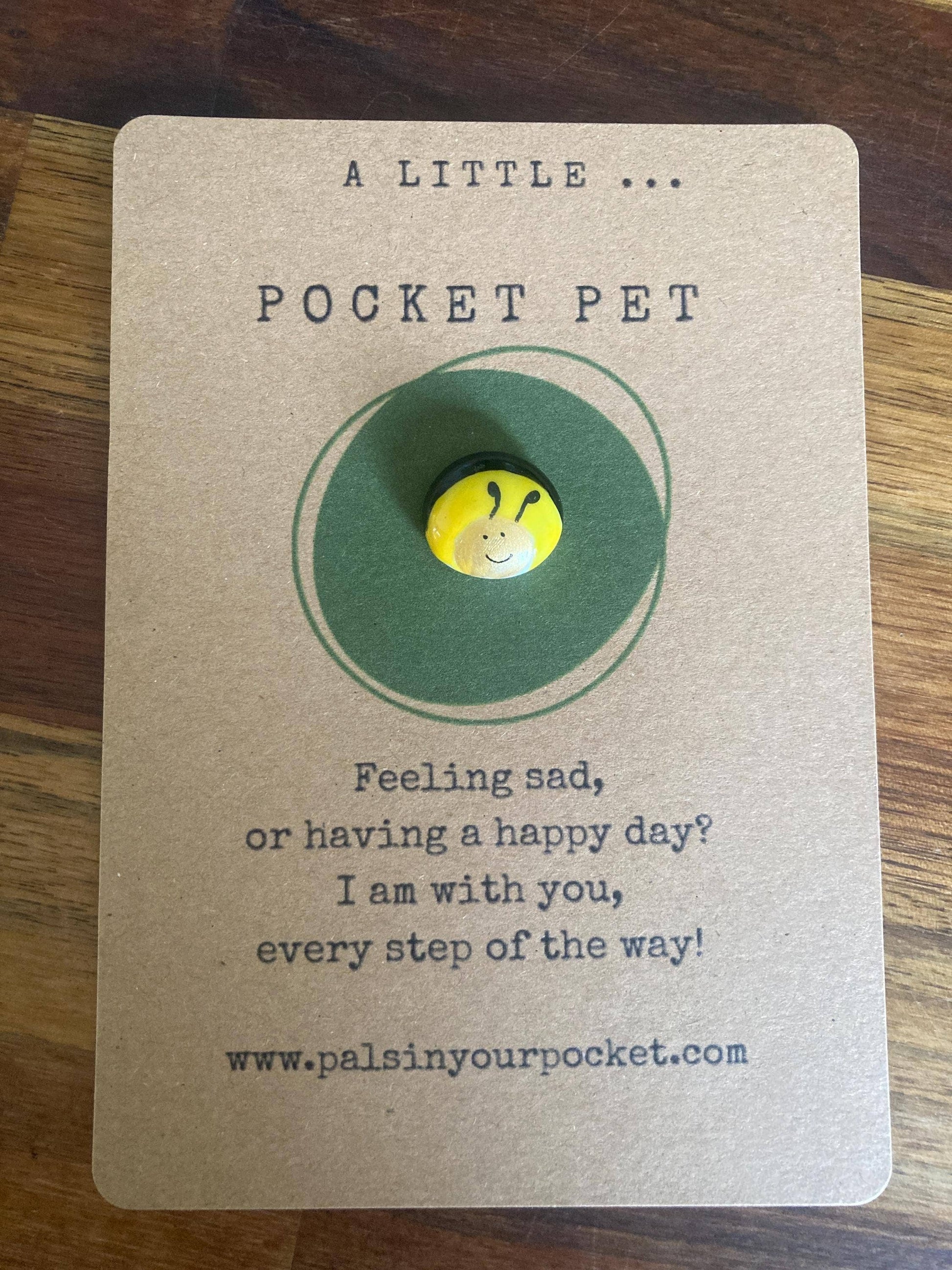 Pocket pet button on a card with text and a website URL