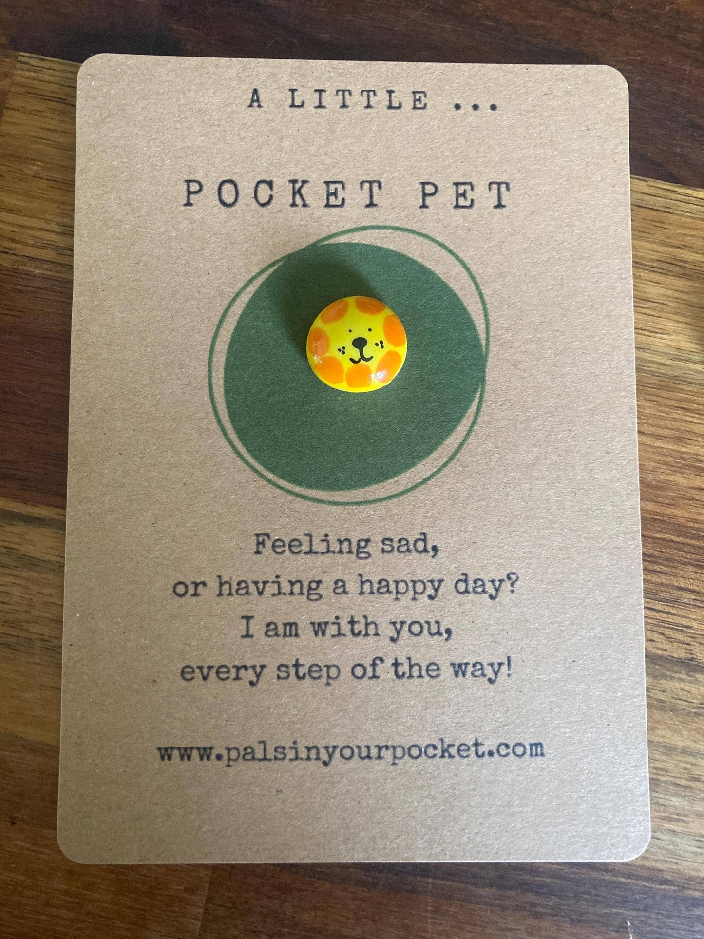 Pocket pet charm on a card with text 