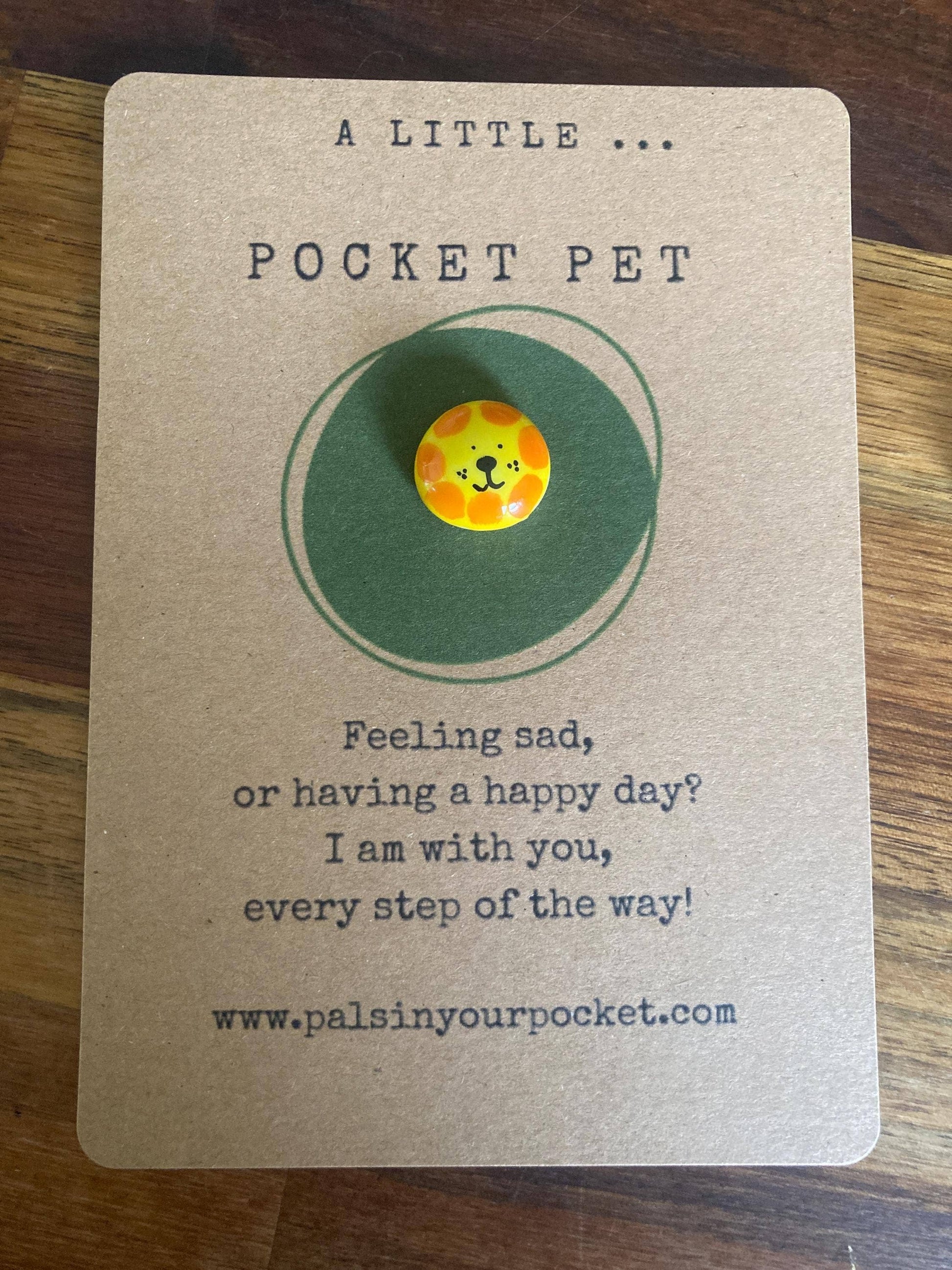Pocket pet charm on a card with text 
