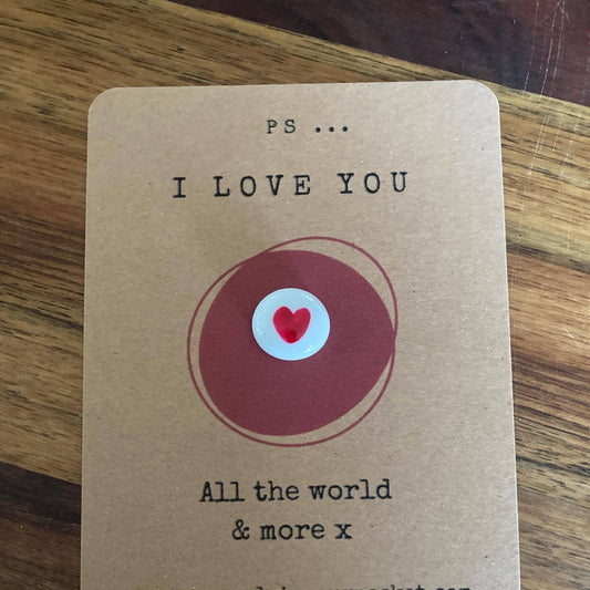 Kraft paper card with 'I Love You' message and heart design on a wooden surface