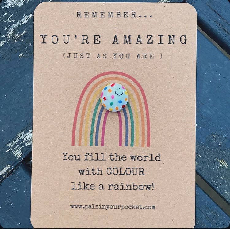 Card with rainbow and polka dot cloud illustration on a blue textured background