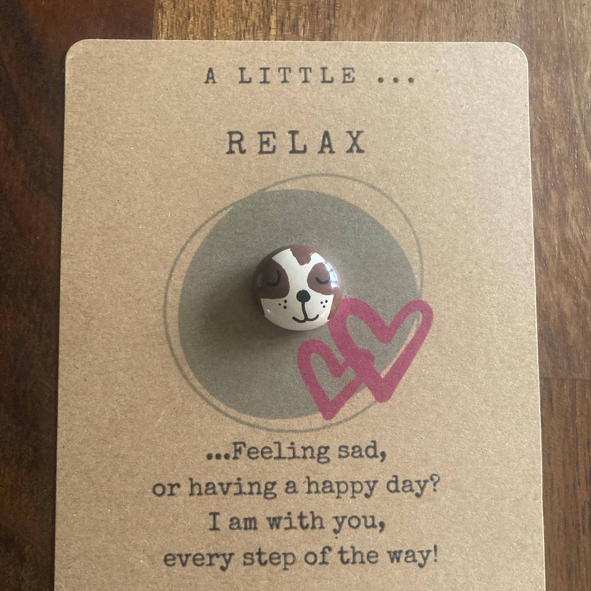 Pin with a sloth design on a card with text L
