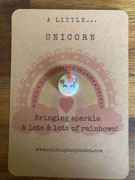 Unicorn button on a kraft paper card with text